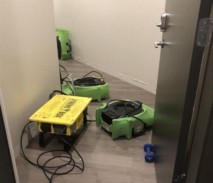 two green air movers on the wood floor. 